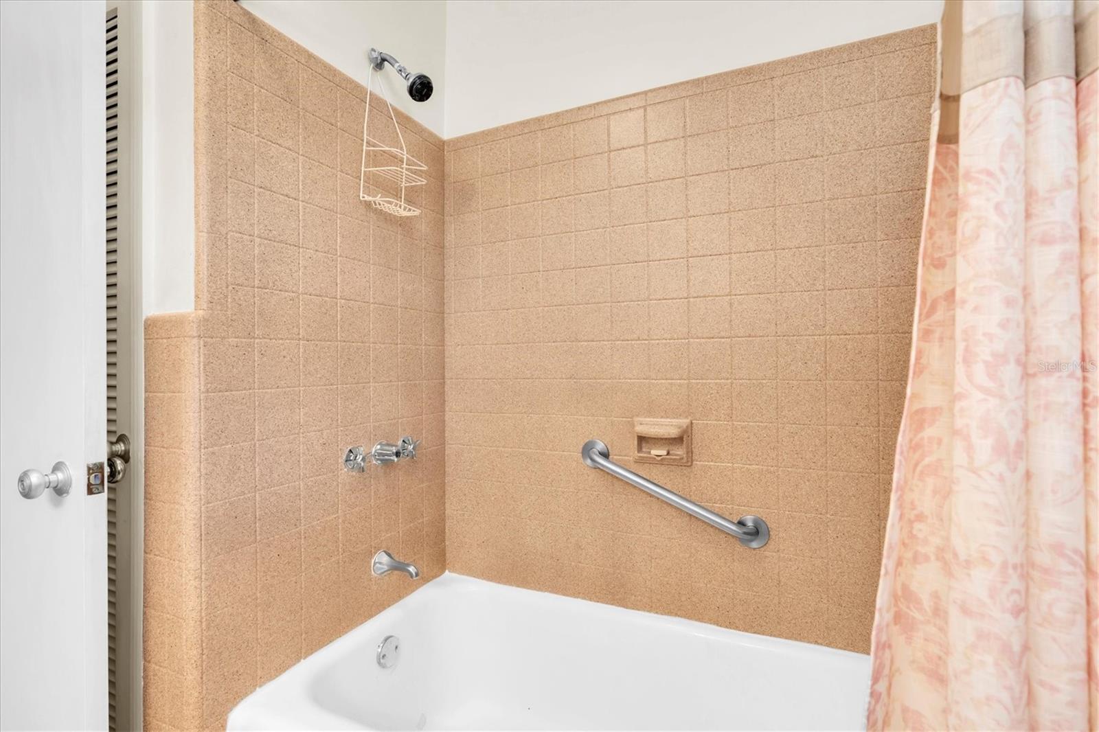 Tub/Shower downstairs bathroom with large inen closet