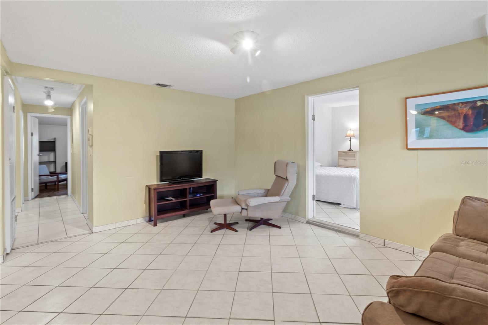 View from front door. Front bedroom on right through door.  Hallway to office and laundry rooms as well as 2 bedrooms and bath.