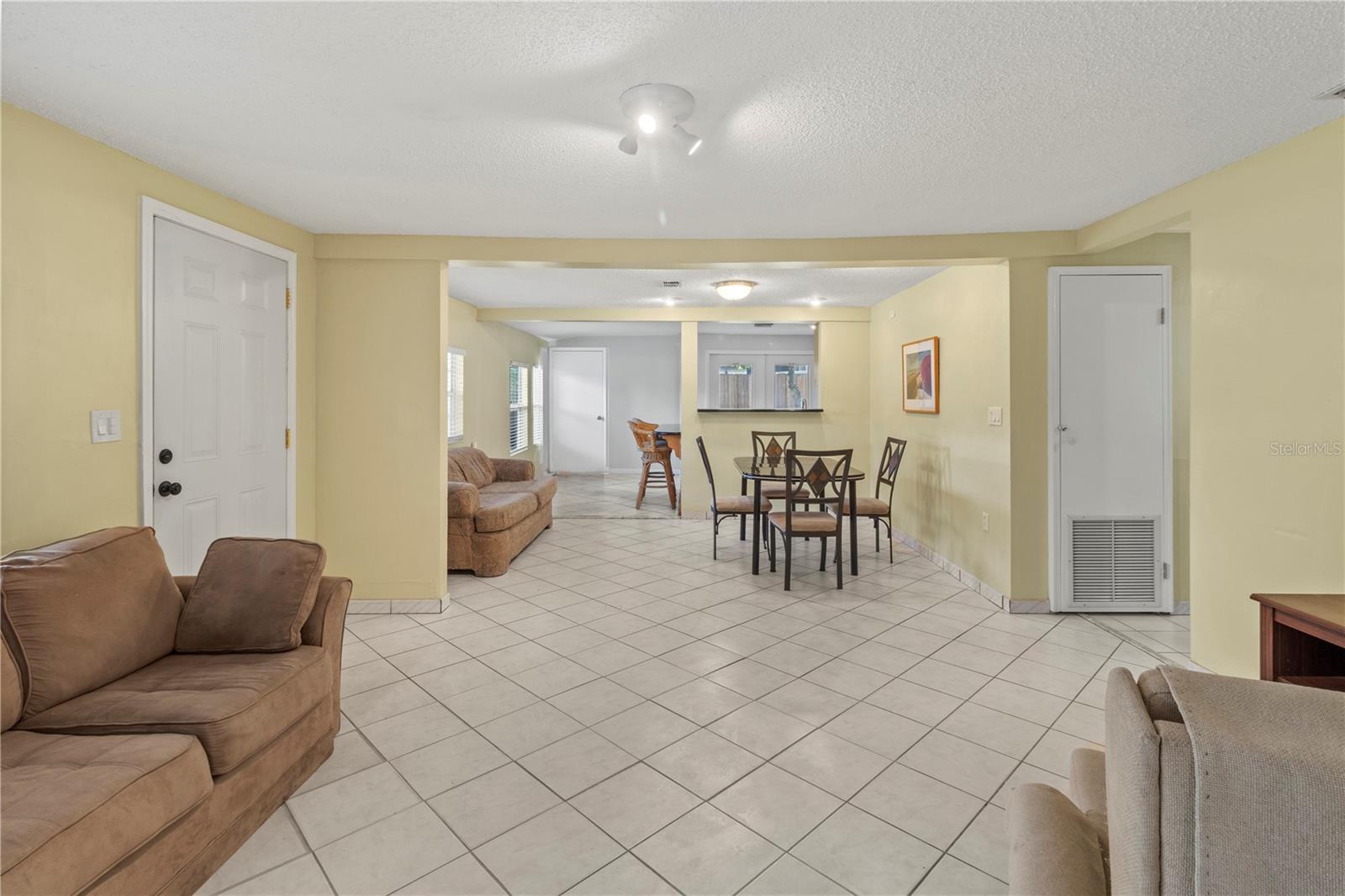 Open floorplan from living room through dining room into kitchen.