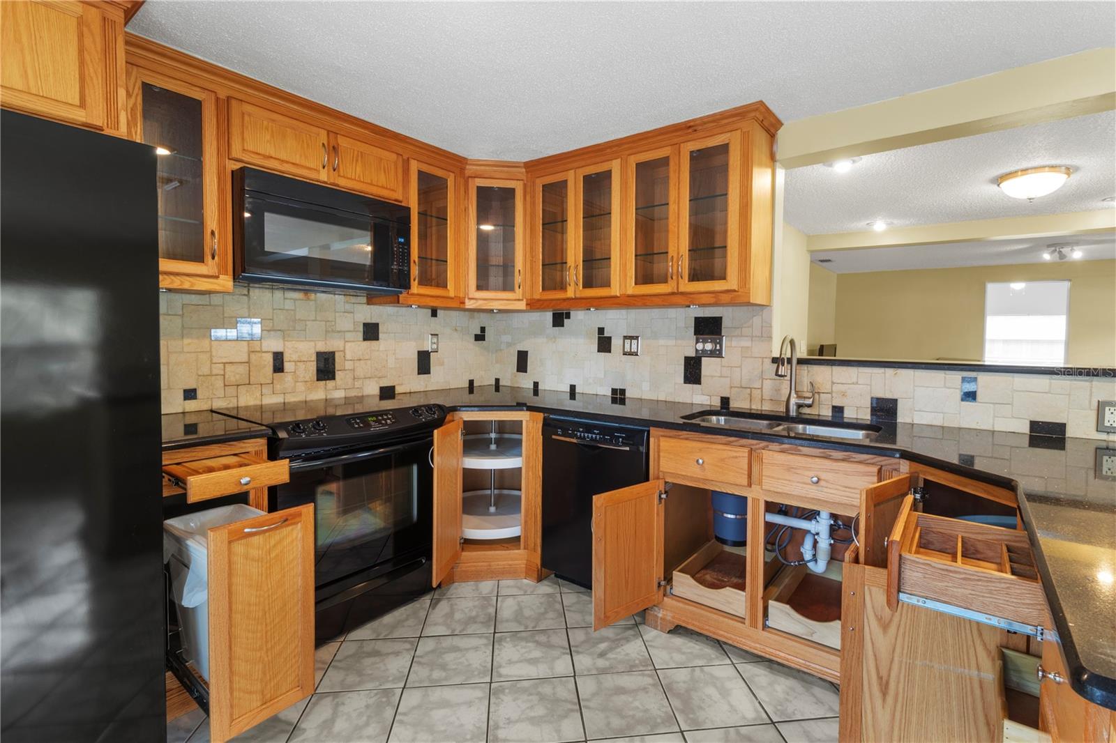 Tricked out cabinets with sliding shelves, 2 lazy Susan's, cutting board over trash can, utensil divider.