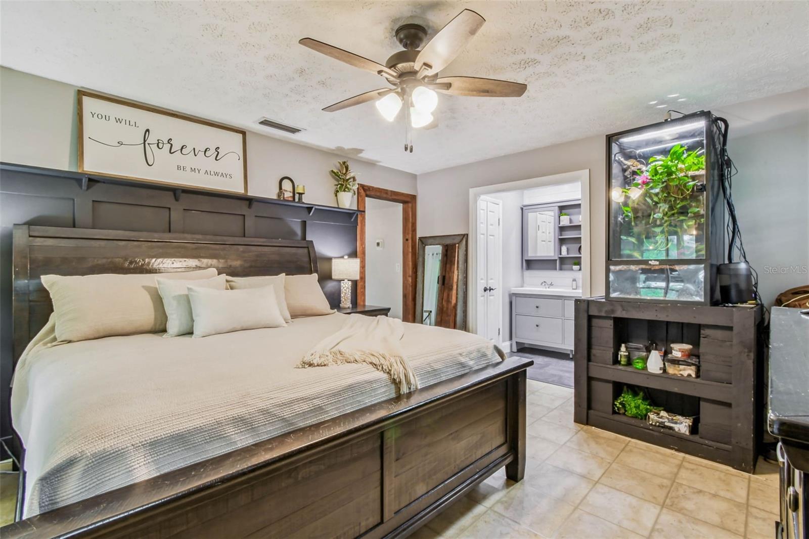 The primary suite has plantation shutters and a modern board and batten accent wall with a built-in shelf.