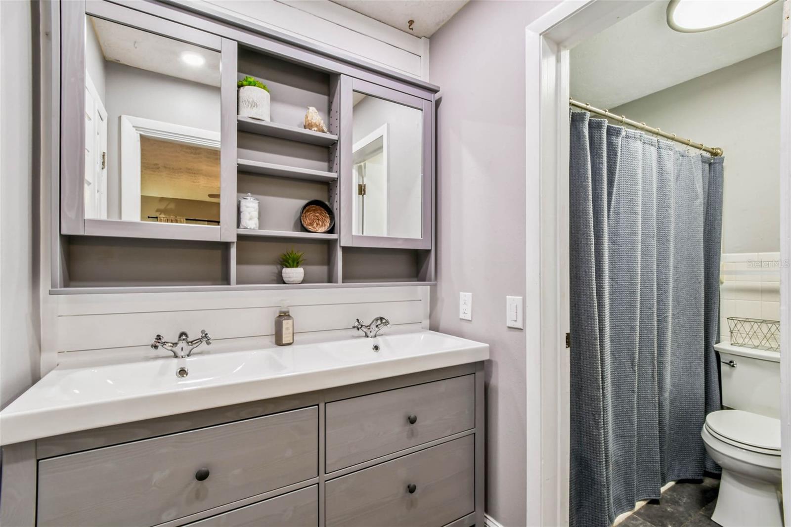 The shiplap accent wall and built-in shelving unit is so charming and pragmatic in this space.