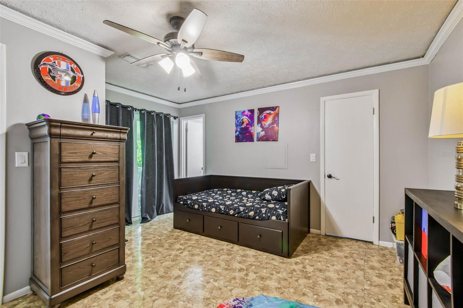 The secondary suite has its own private bathroom, a walk-in closet, a huge floor to ceiling window, and its own dedicated back door entrance that leads out to the covered, rear deck.