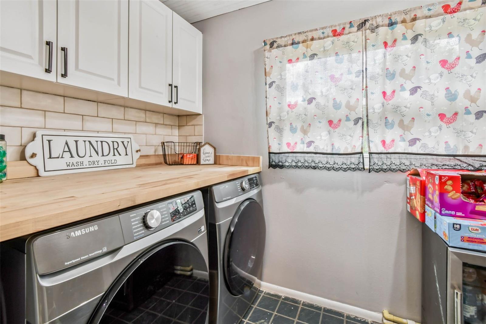 The laundry room has built-in shelving and cabinetry for maximum functionality.