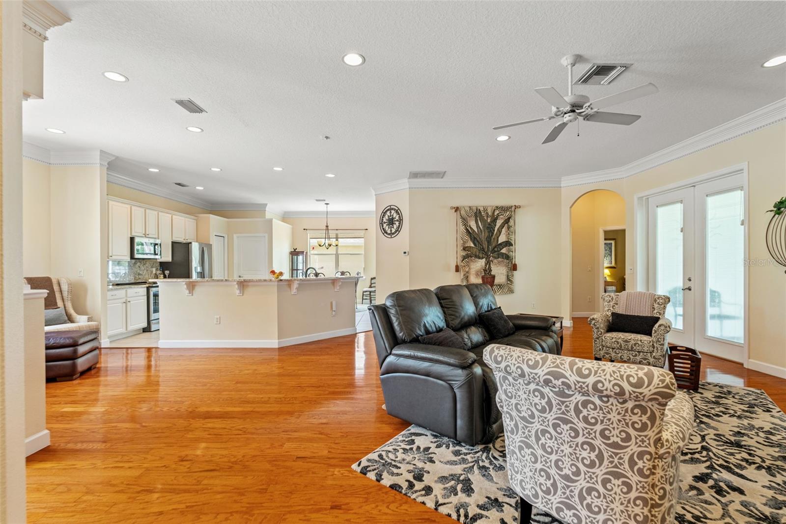 Generously sized main living area with recessed lighting and open flow to dining and kitchen.