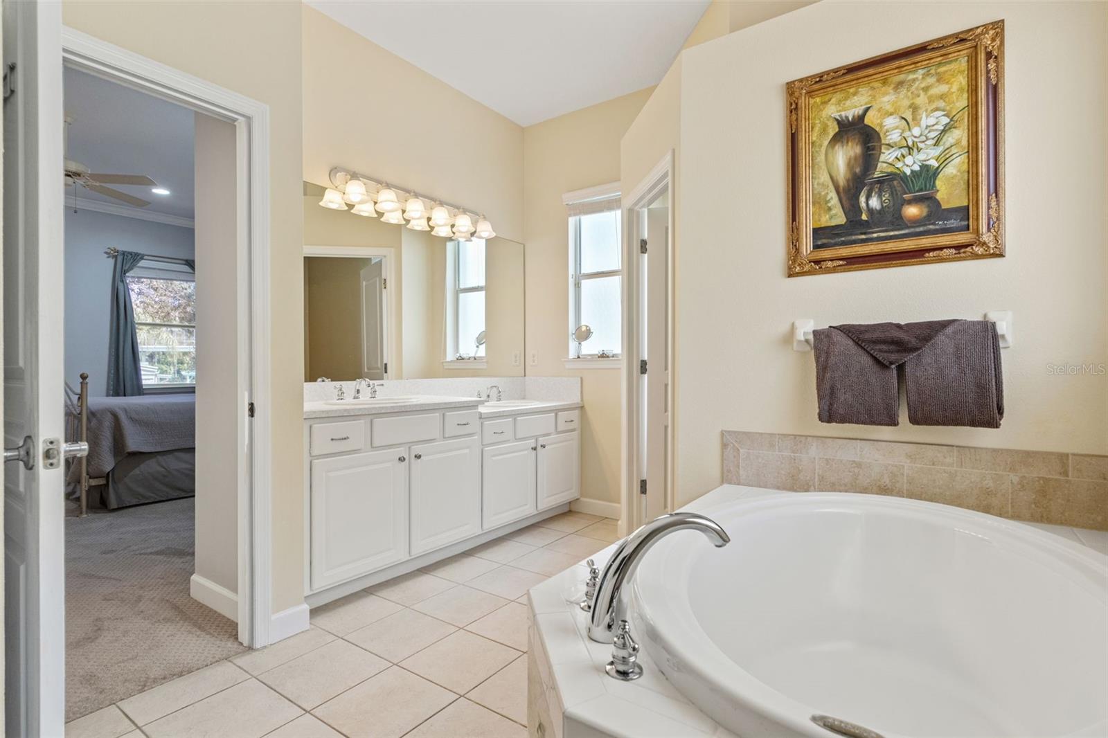Retreat to your spa-like owner’s bath, complete with a deep soaking tub, dual vanities, and abundant natural light.