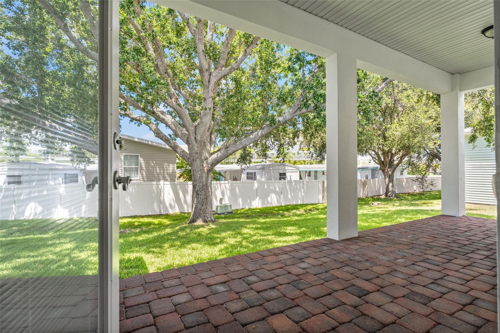 Step outside to your covered patio and take in views of the lush backyard shaded by mature trees.