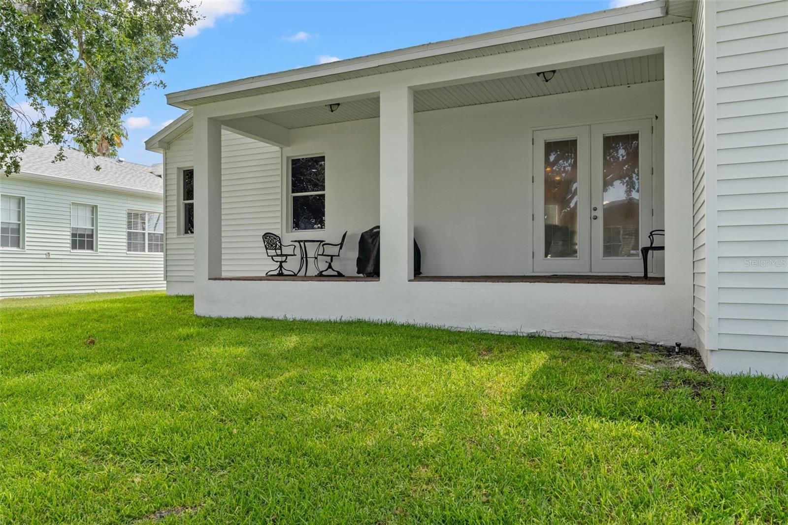 French doors open to the covered patio, blending indoor comfort with outdoor living.