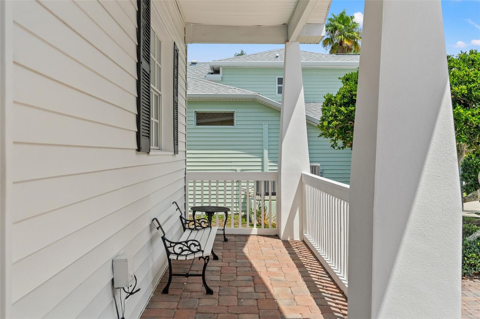 Covered porch with space for seating, perfect for enjoying morning coffee or greeting guests.