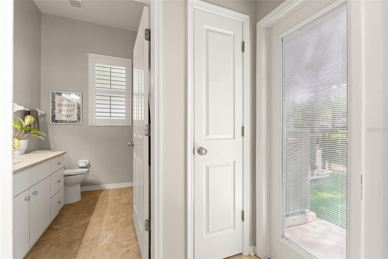 Conveniently located near the 4th bedroom, this guest bath includes neutral tile, a single-sink vanity, and a window for added brightness.