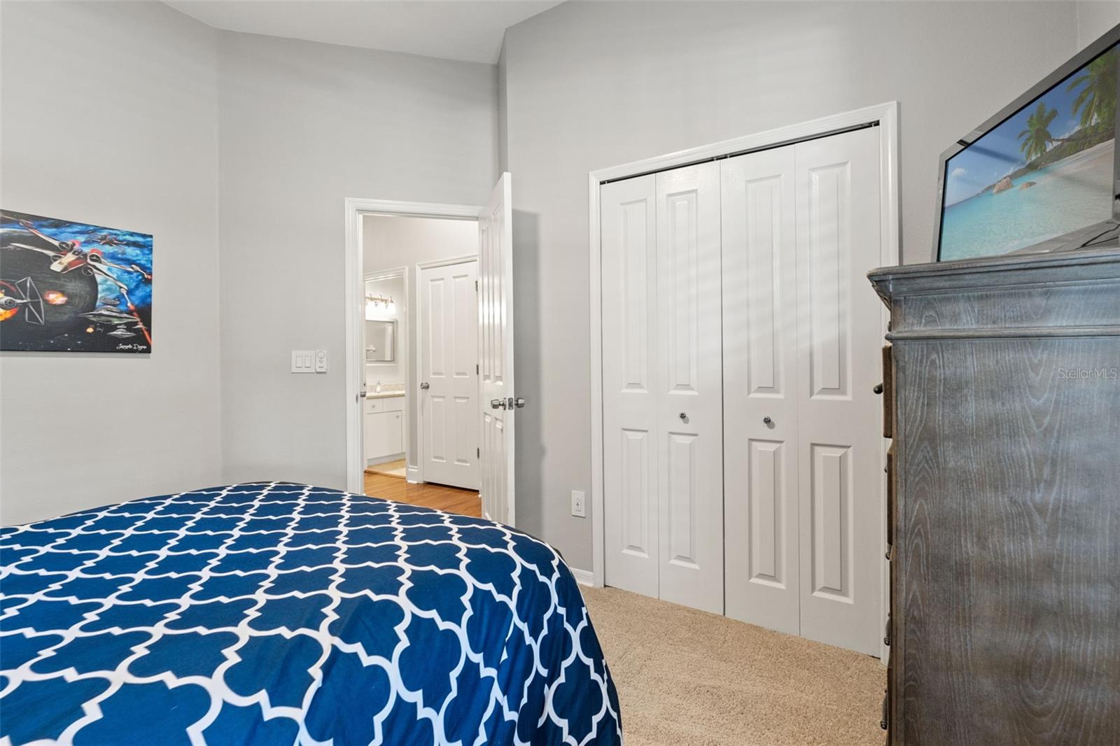 View of the closet and adjacent bathroom access. Neutral finishes and natural light maintain a calm and flexible environment.