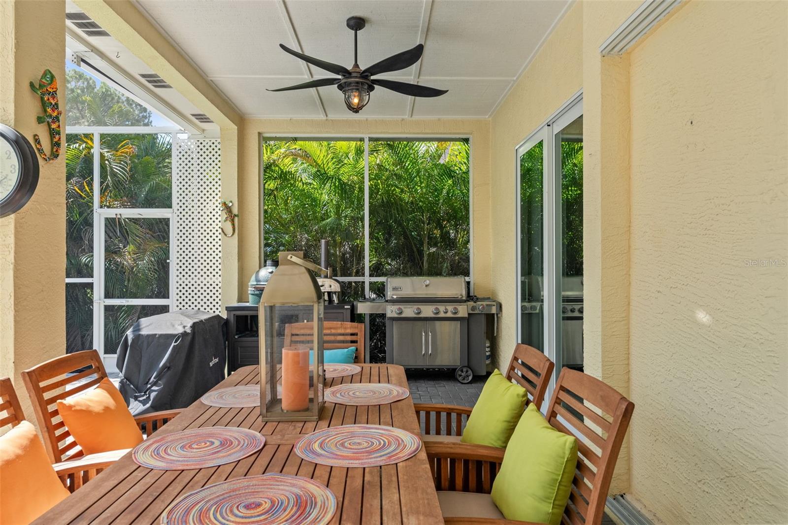 Enjoy year-round entertaining on this spacious screened-in lanai, complete with dual ceiling fans, a built-in grilling station, and direct access to the pool.