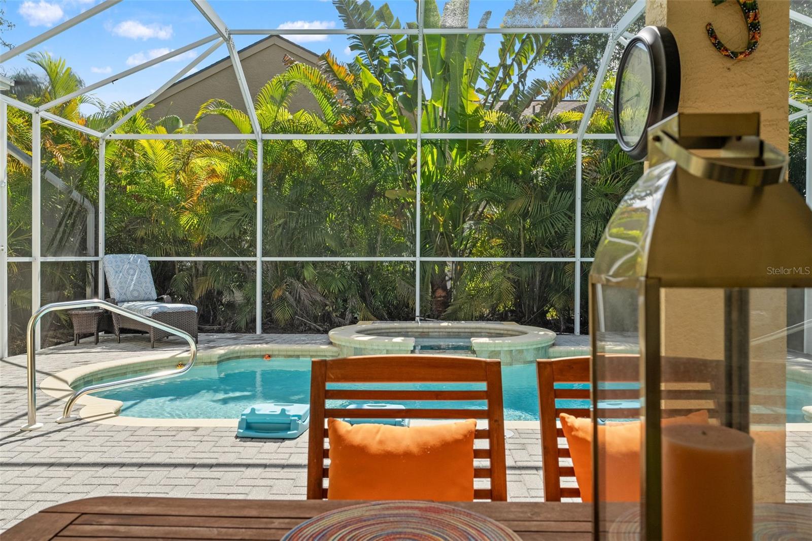 Relax with pool views from the comfort of the lanai, with a clear line of sight to the spa and surrounding greenery.