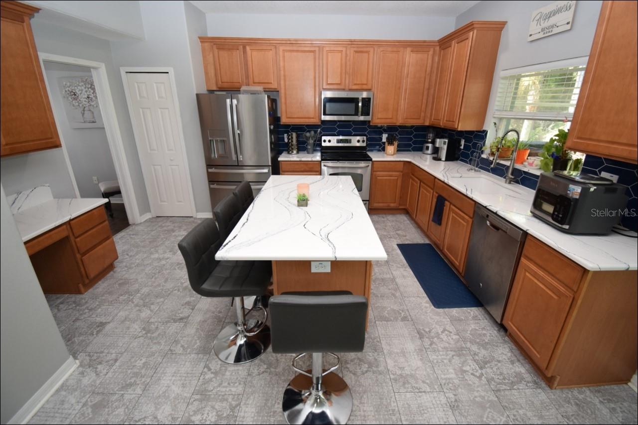 Kitchen with top grade Cambria Quartz counter tops, backsplash & solid wood cabinets