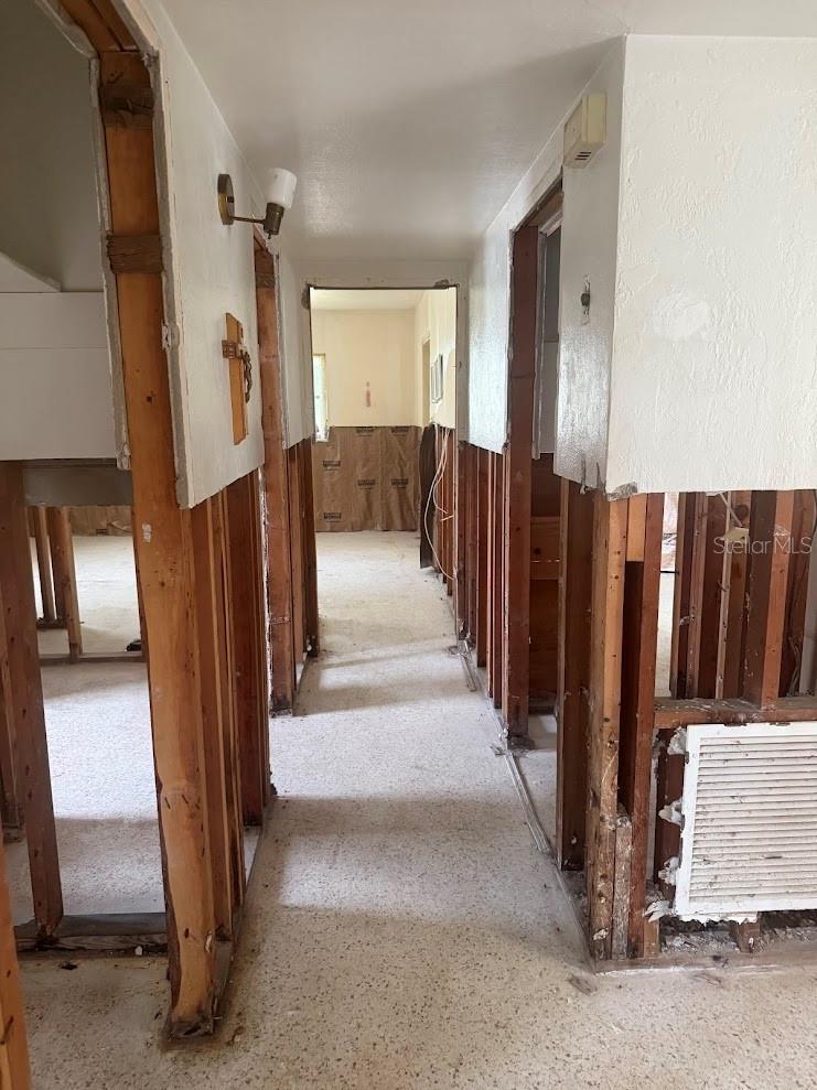 The hallway leads to the full bathroom and second bedroom.