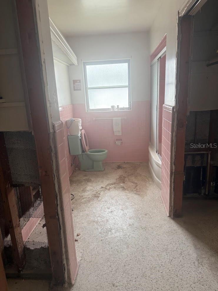 The second bathroom has terrazzo floors and is ready for a fabulous renovation.