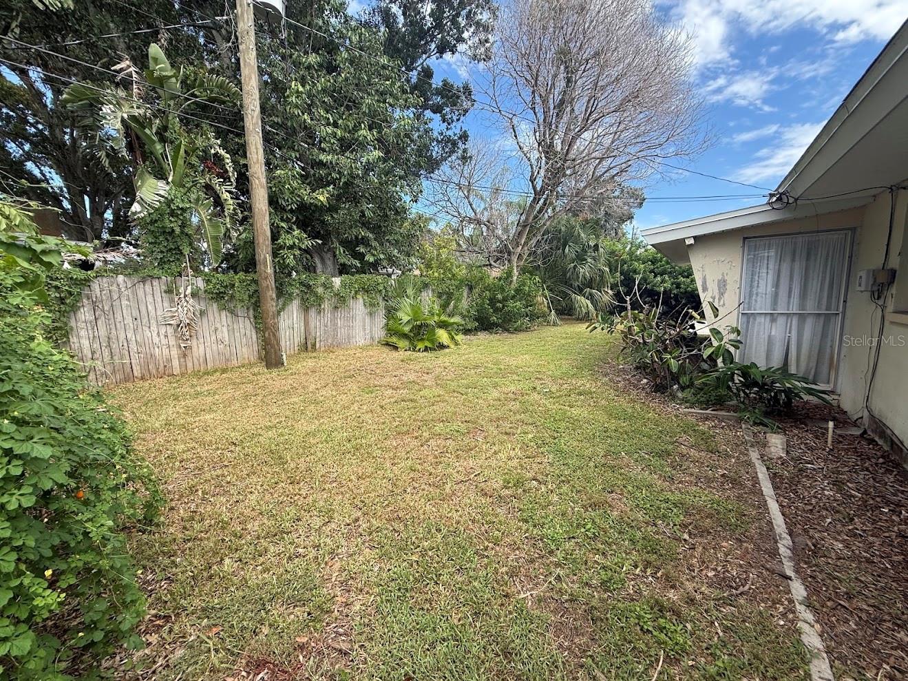The yard features mature landscaping and offers wonderful privacy.