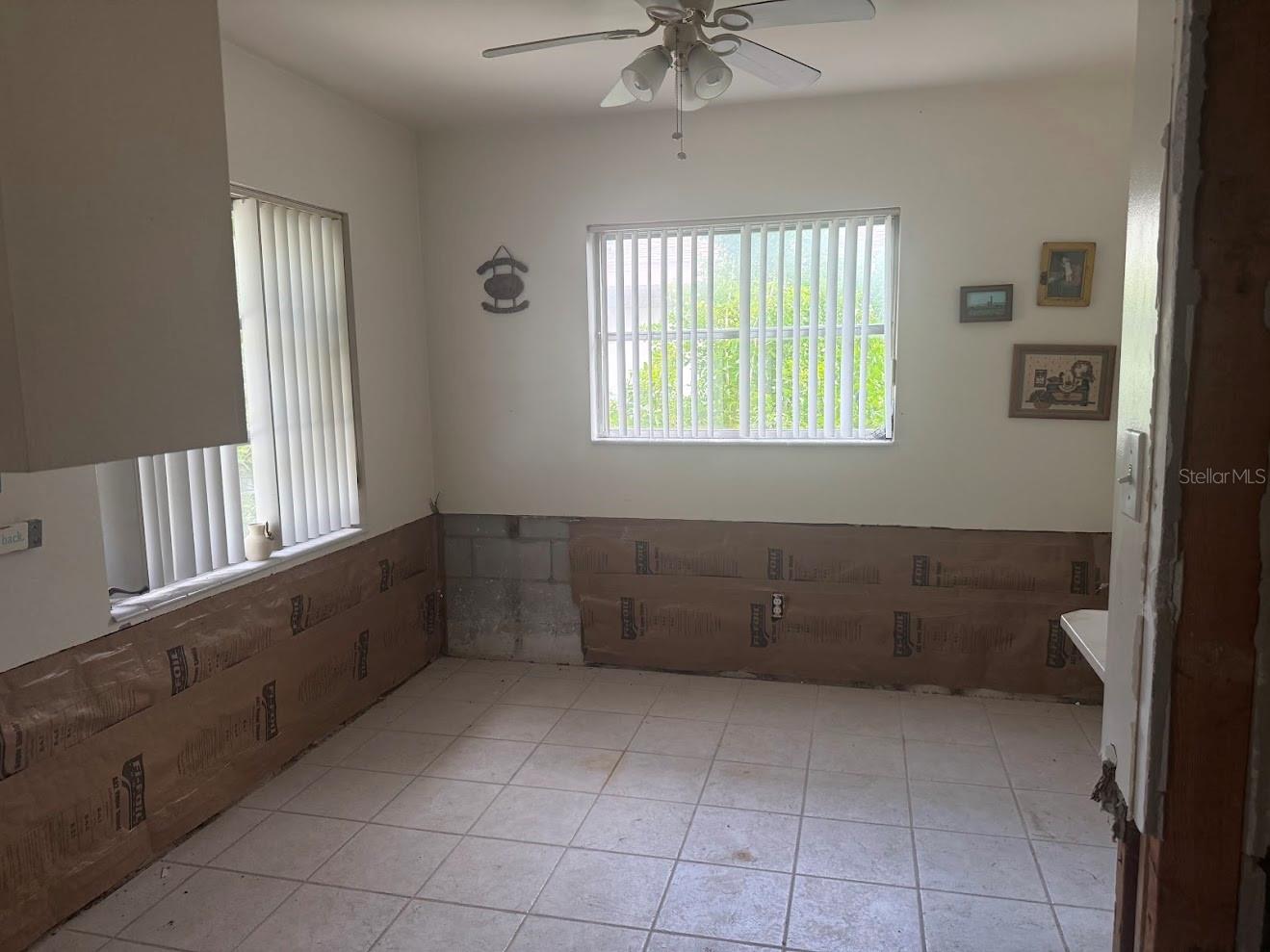The kitchen offers space for a kitchen table with views of the yard.