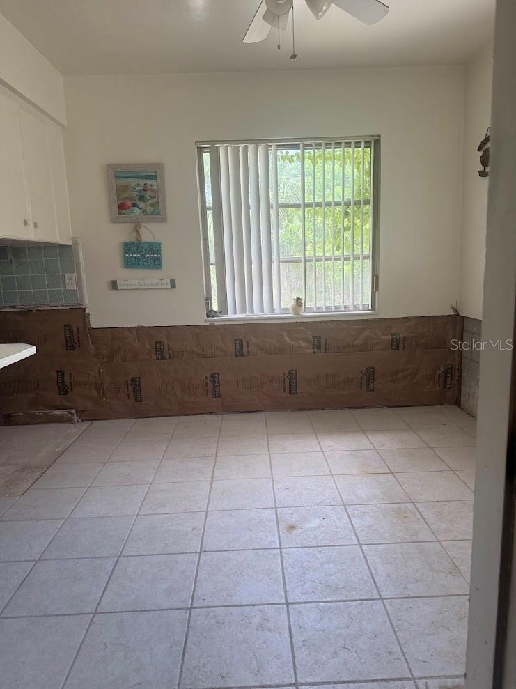 The kitchenette space is large with views of the yard.