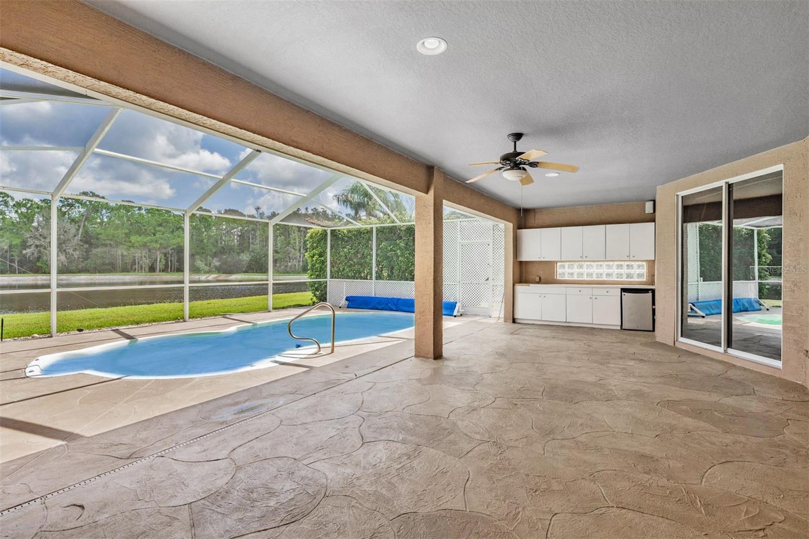 Covered lanai with kitchenette and built-in cabinets