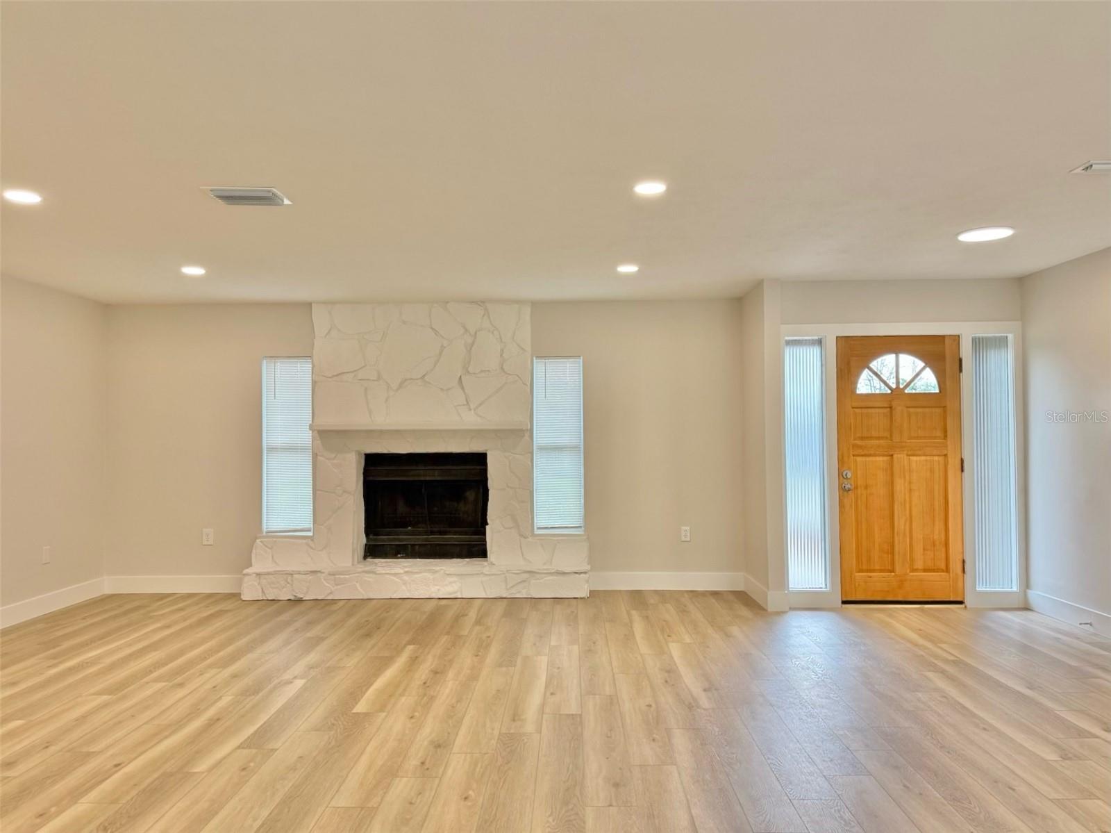 Living area. Front door & fireplace