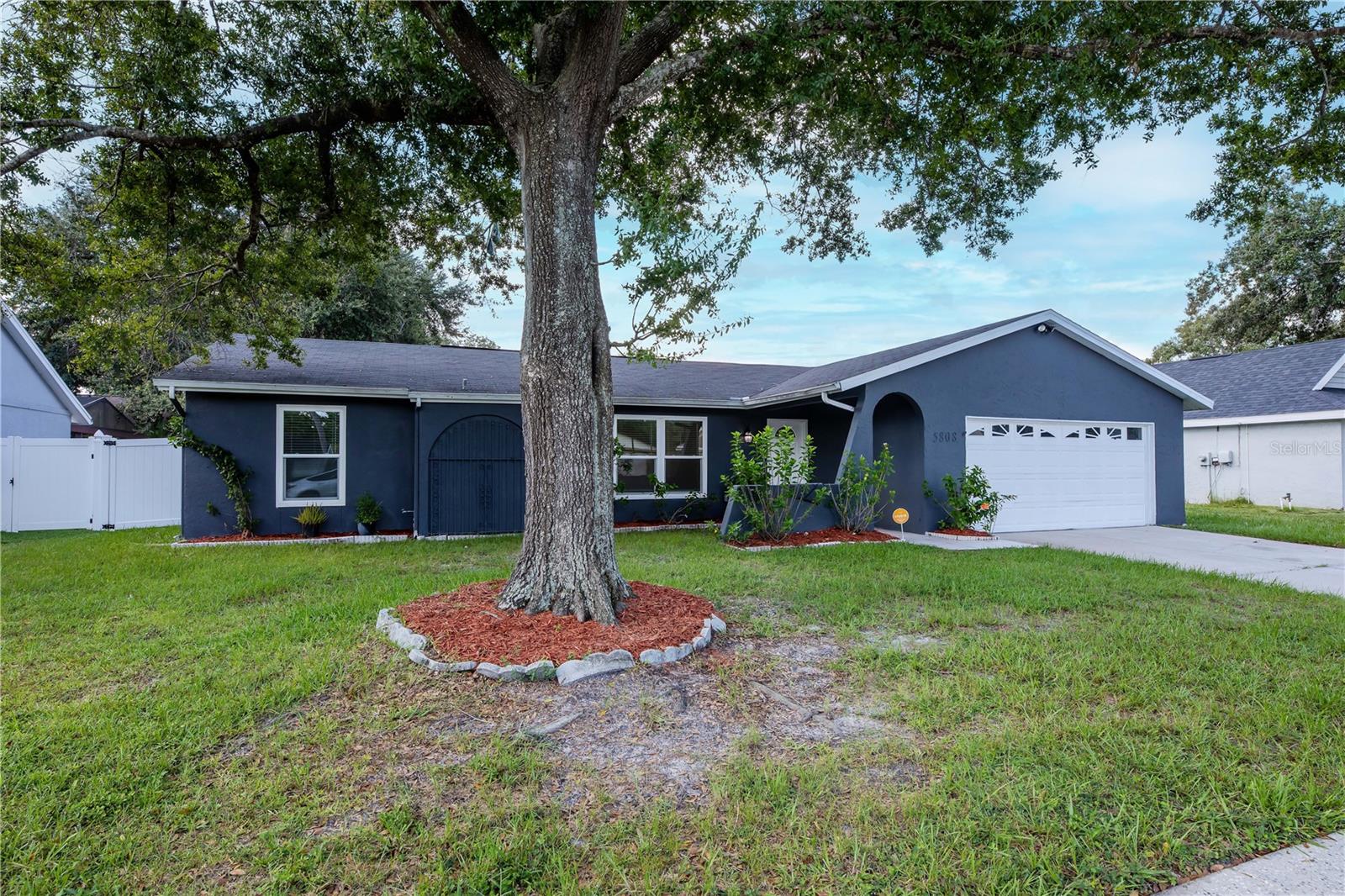 Beautifully maintained front elevation with new exterior paint, manicured landscaping, and an inviting entryway that makes a lasting first impression.
