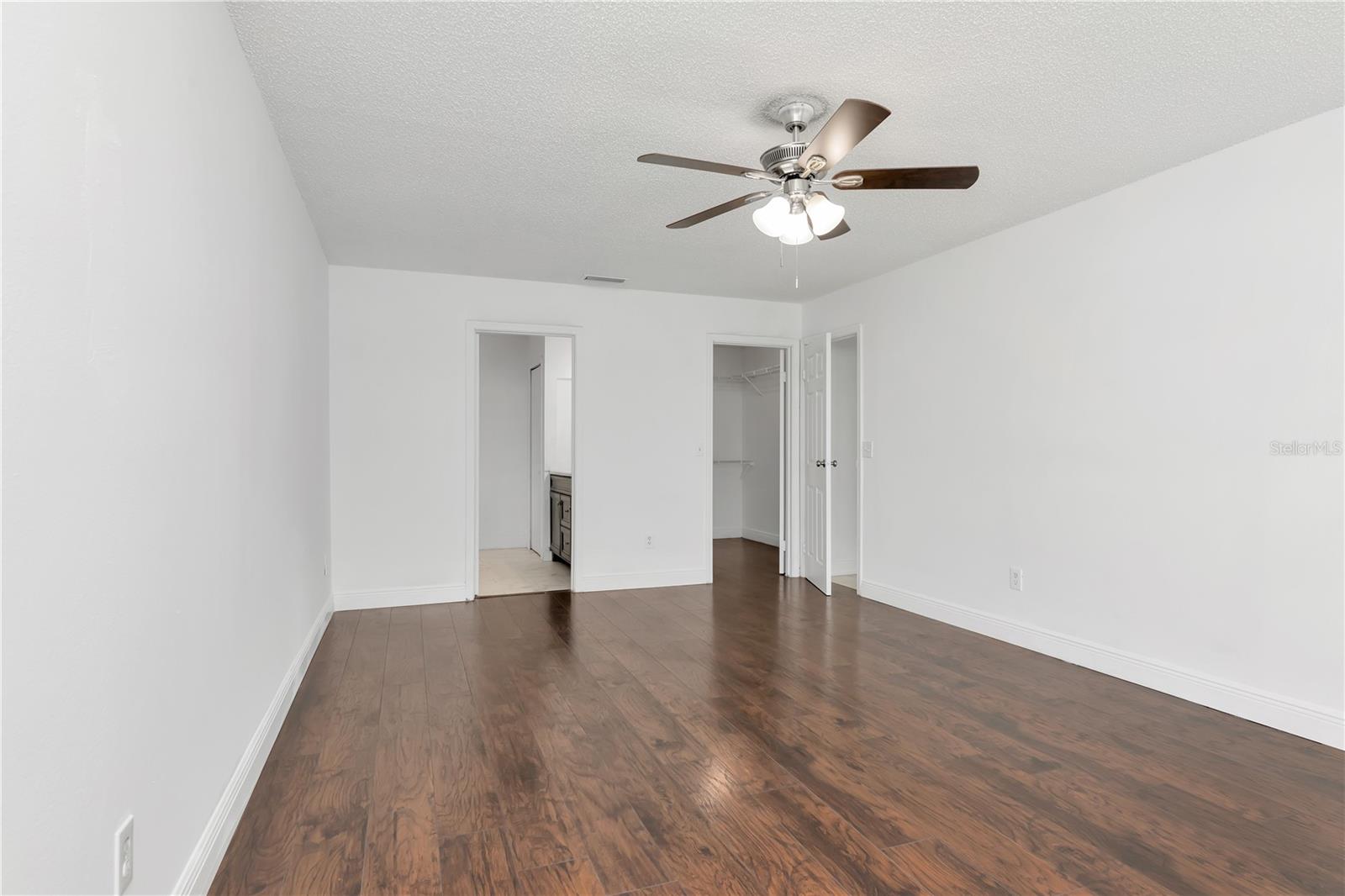 Master bedroom with attached bath and walk in closet