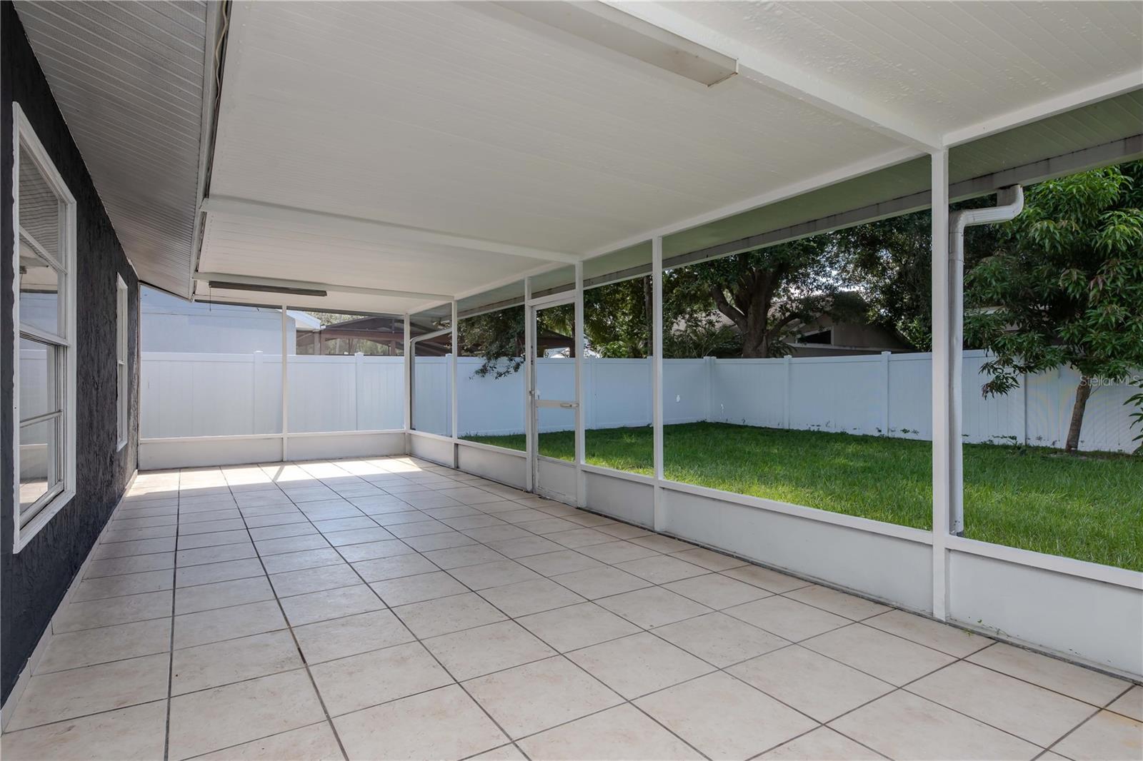 This covered patio and lanai create a flawless transition between indoor comfort and outdoor beauty