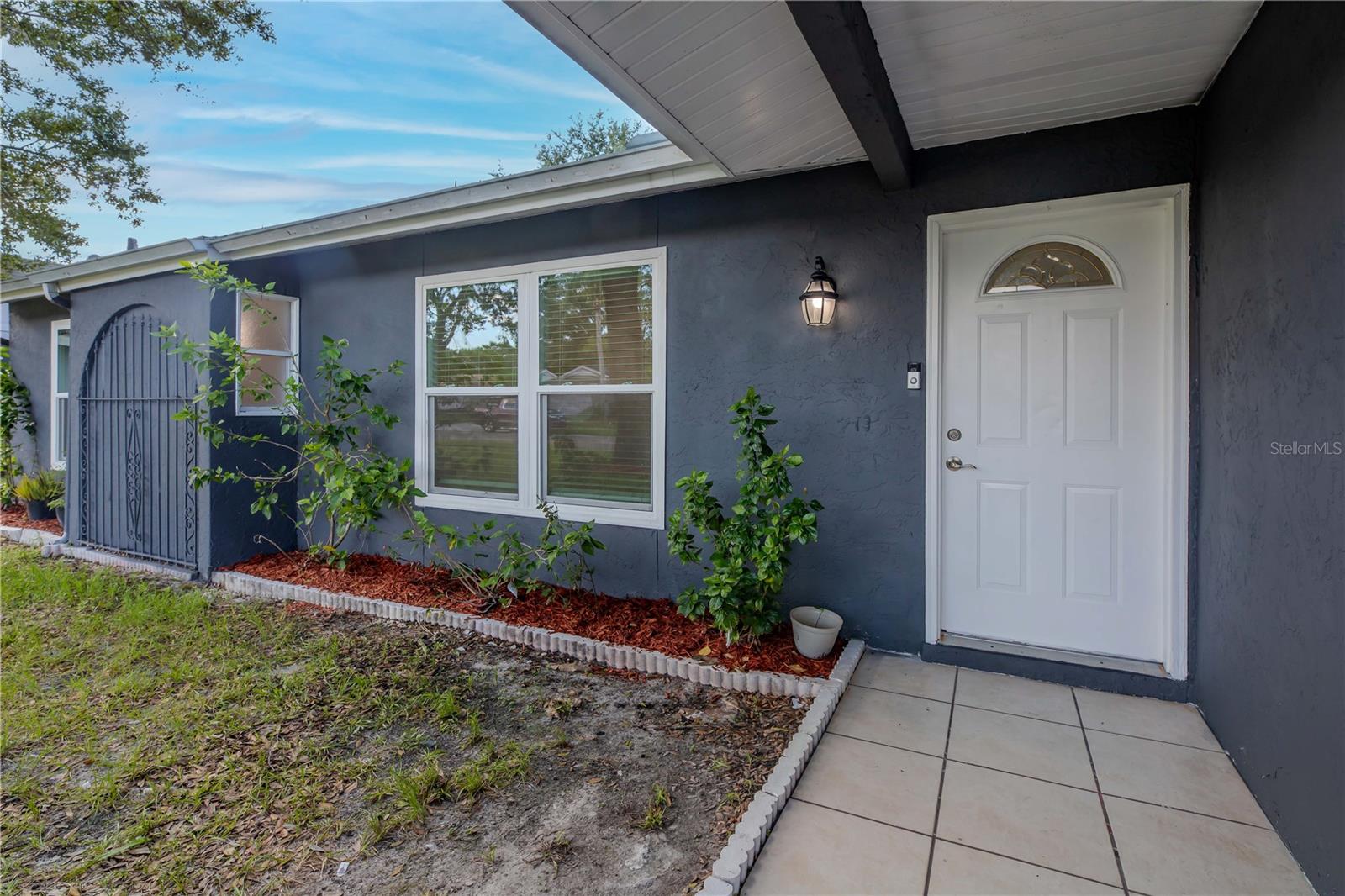 Charming front entry with a welcoming covered doorway, perfect for greeting guests and enjoying a touch of shade.