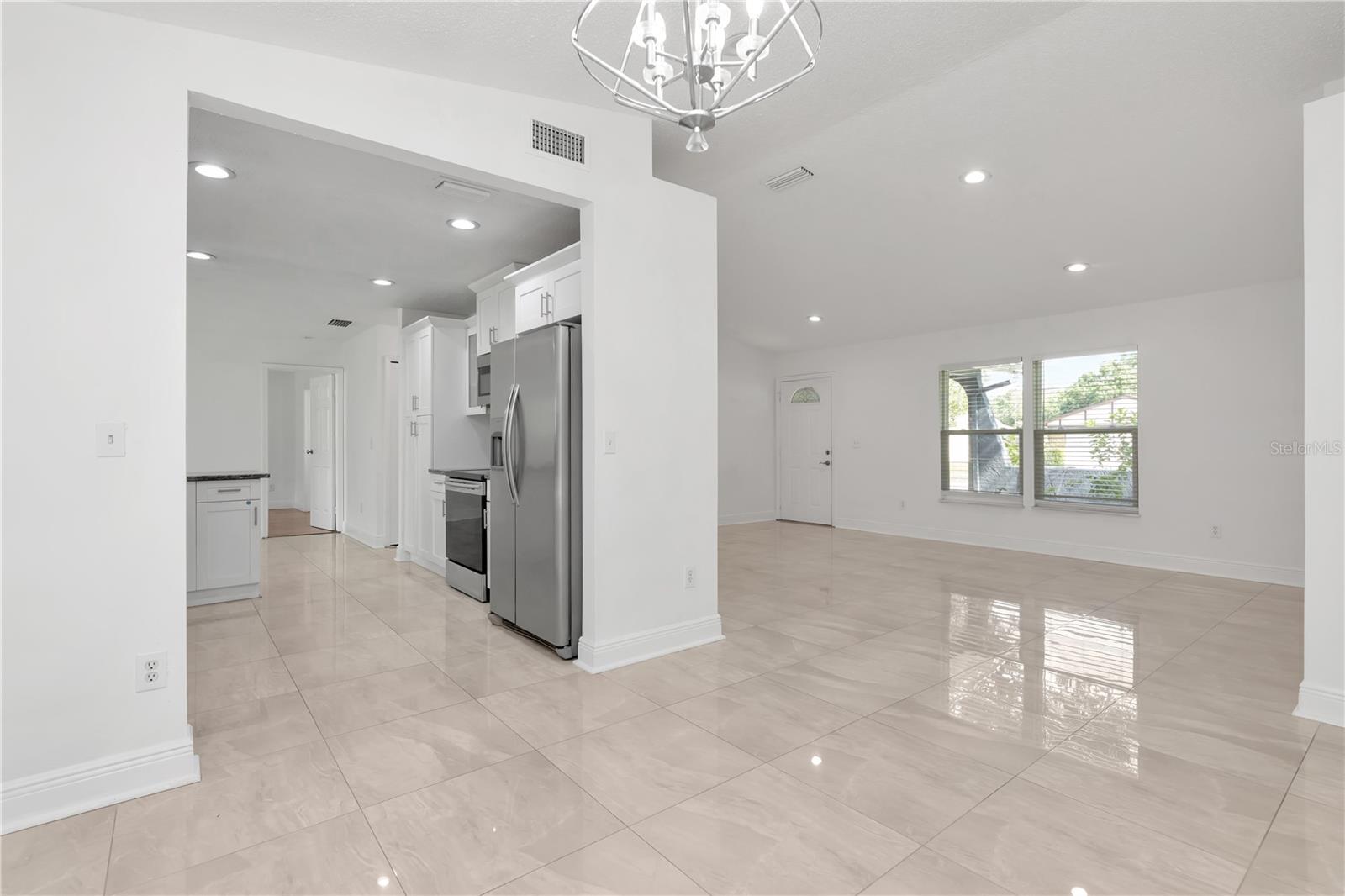 Versatile area that can easily be arranged as a cozy family room or combined with the dining area, all just steps from the kitchen.