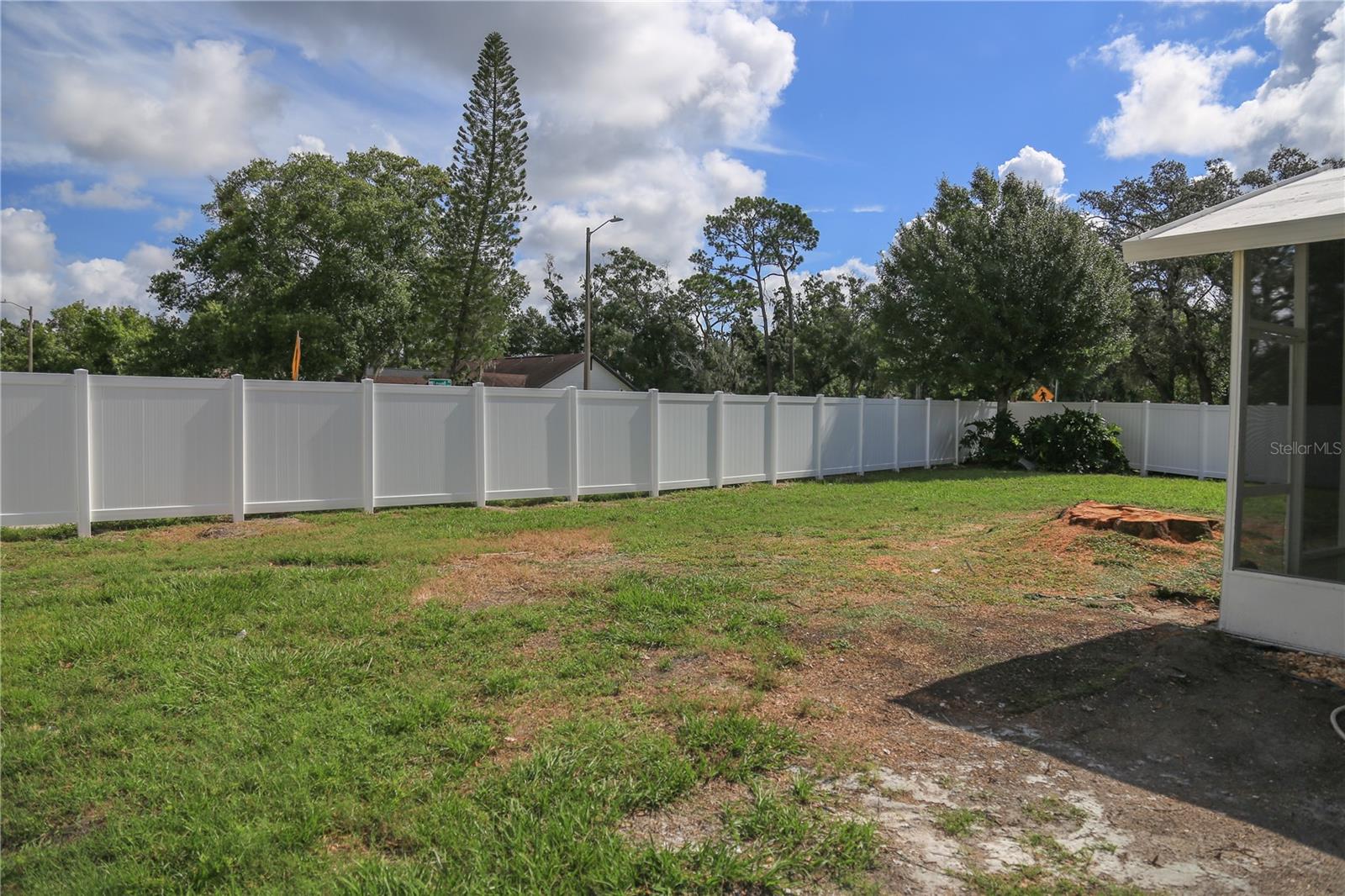 Exterior backyard with new vinyl fence
