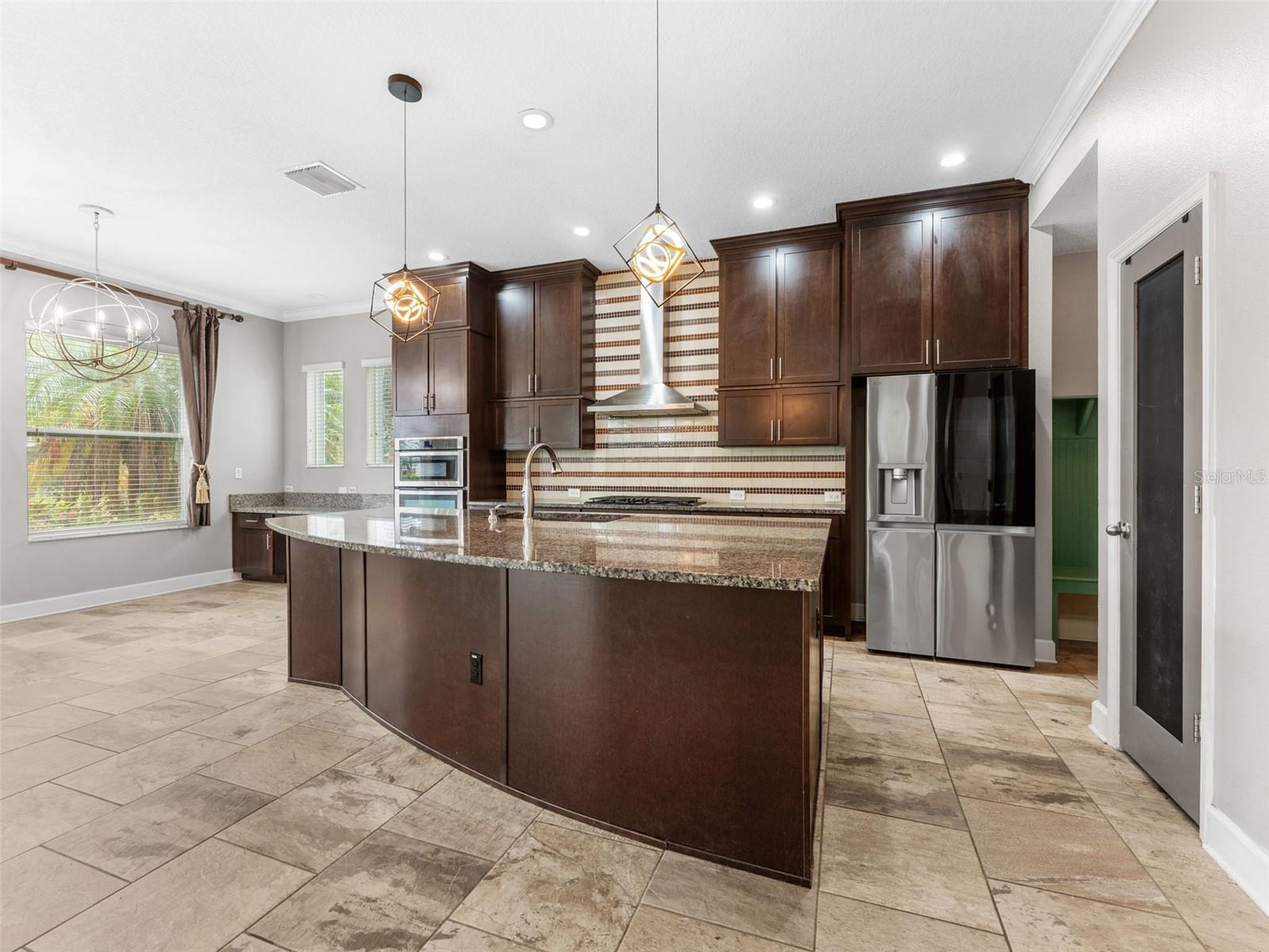 Beautiful Kitchen with granite countertops, stainless steel appliances, and, tile backsplash!