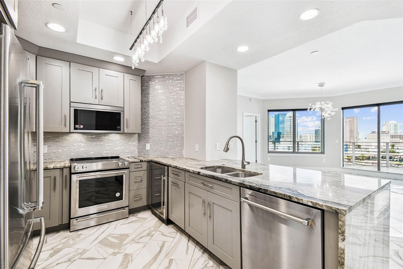 Newly redone kitchen with KitchenAid appliances and beverage cooler