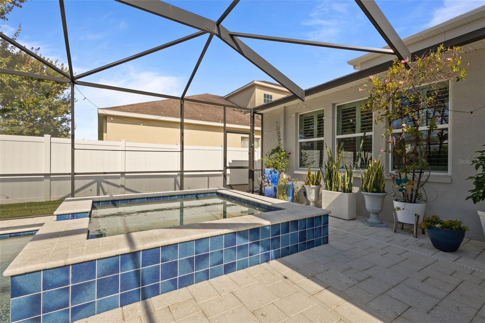 Saltwater heated screened in pool with in ground hot tub