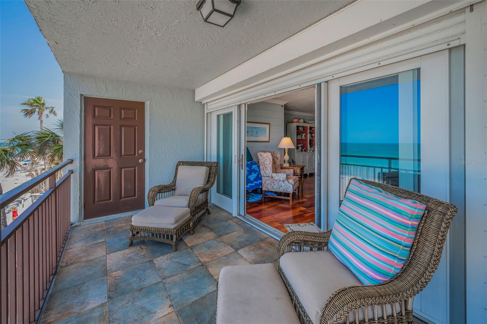 ... Balcony Looking In on Main Floor... Locked Six Panel Door Accesses Staircase to Bottom Level For quick Beach Access.