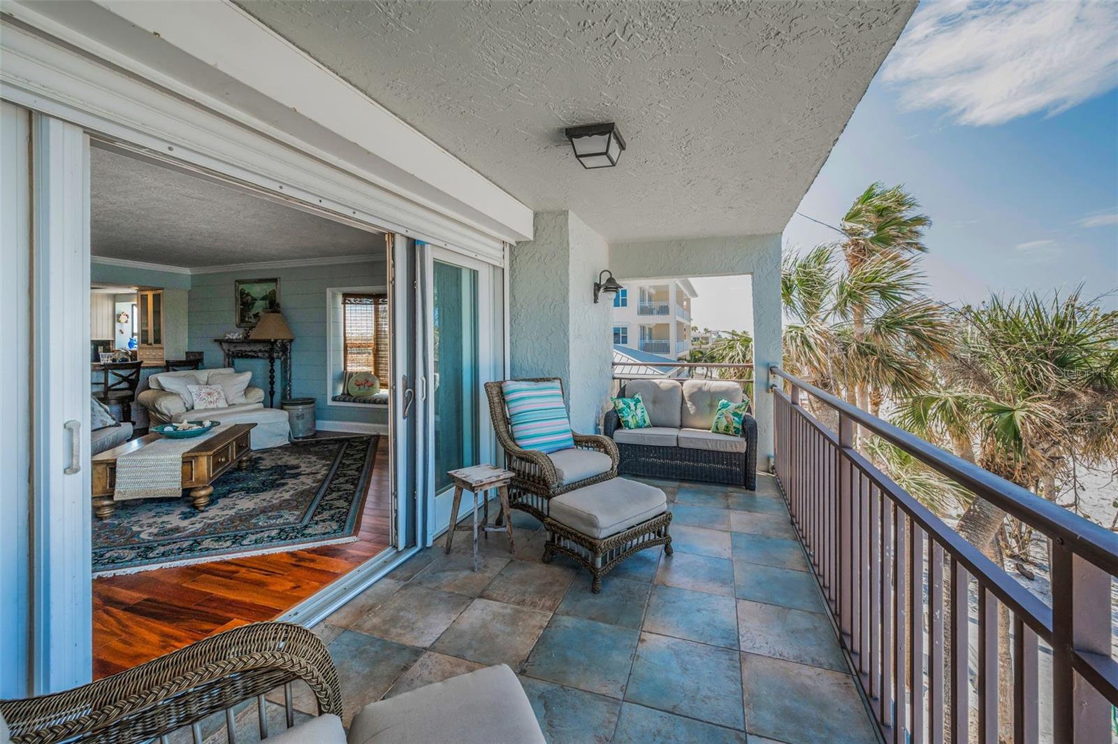 ...Looking Into The Great Room Living Area. NOTE: Storm Shutters Outside Sliding Doors.