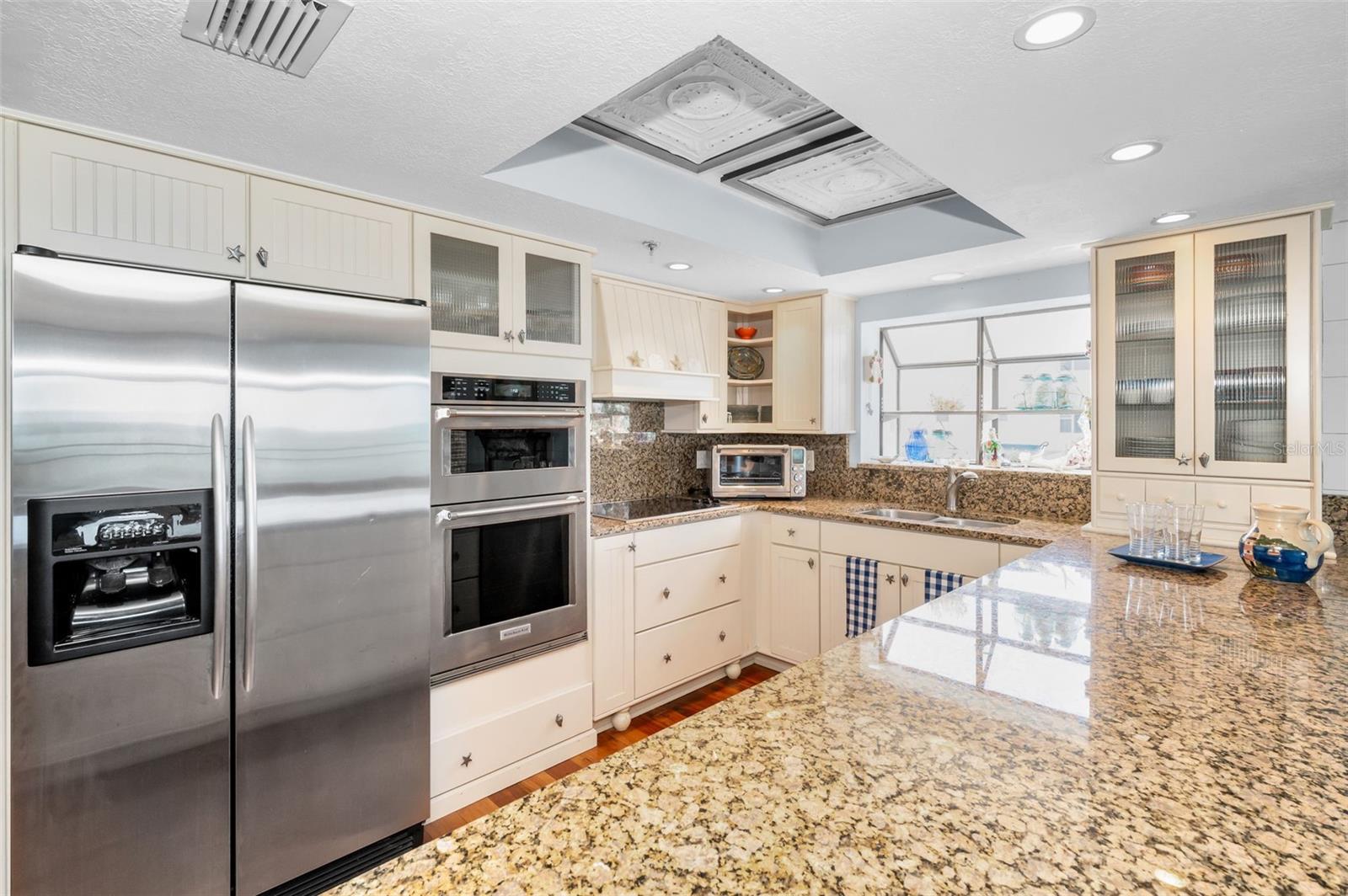 .. The Kitchen is 10.4 in Length  and 11.4 Wide. The Breakfast Bar with a 43" Wide Piece of Granite runs 11.4 Feet..