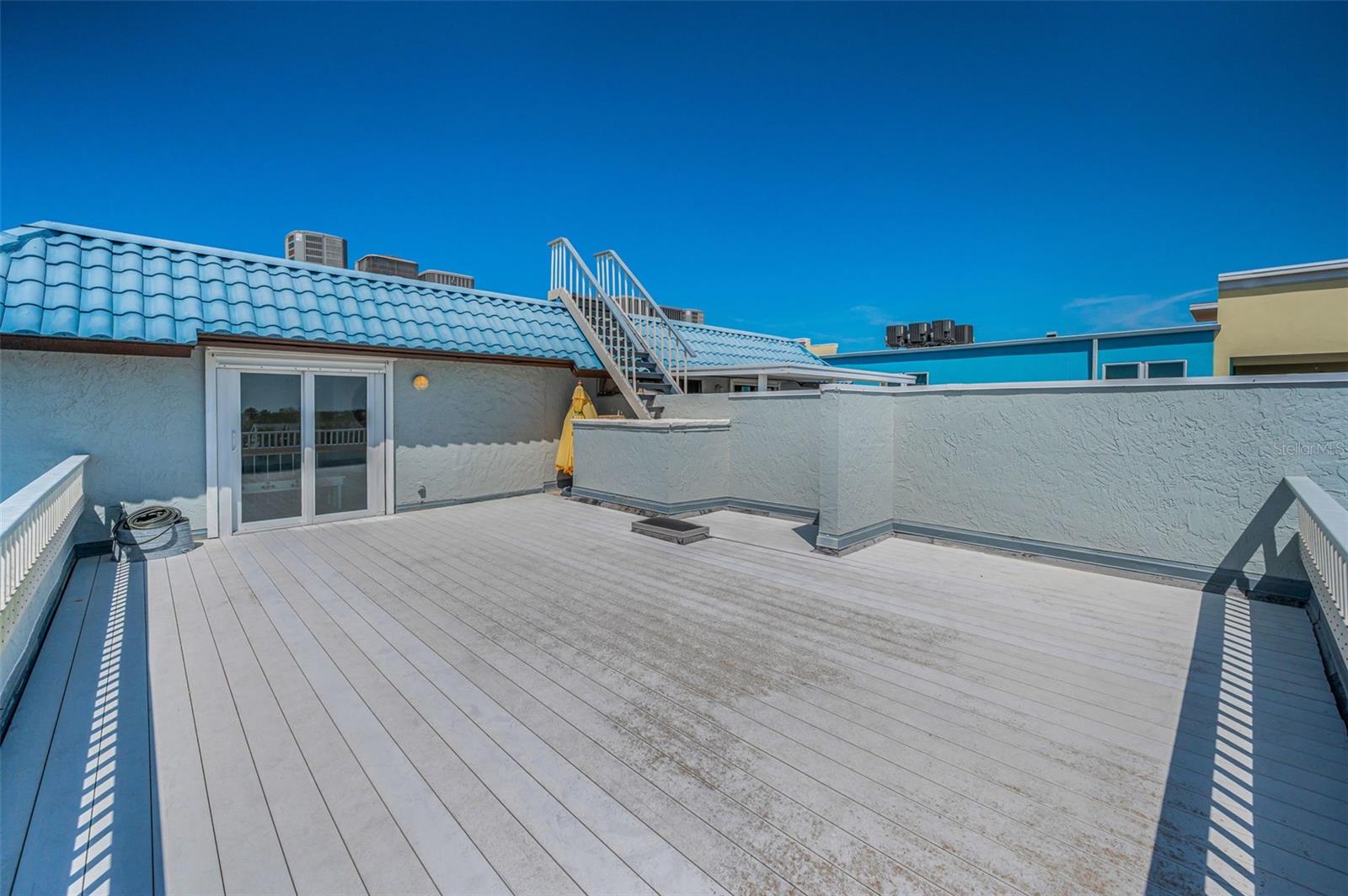 .. Shot of Private 27' x 20' Roof Top Patio / Sundeck. Furniture has been ordered and on it's way.. Balcony Sliders Lead to Loft Room -