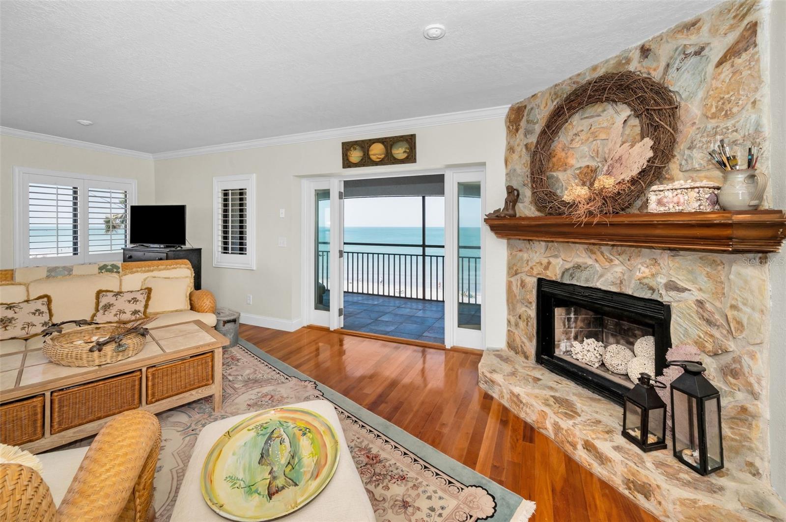 .. Master Suite Top Floor Penthouse #5 SW Corner. View of Fireplace and Gulf Waters. These Doors Swing Out. There Are Electric Storm Shutters on The Outside of Doors . The Owners Have Not Used The Fireplace For Years But it Looks Soooo Nice ..