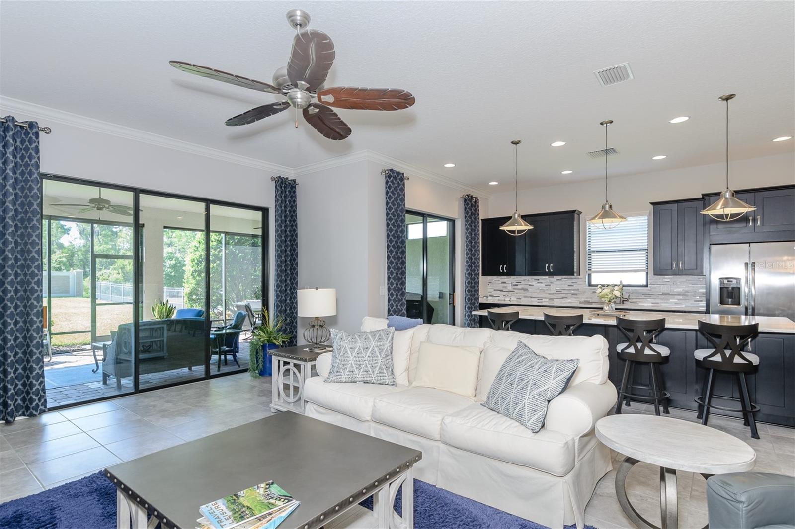 Living room with sliding glass door to outside screened in patio