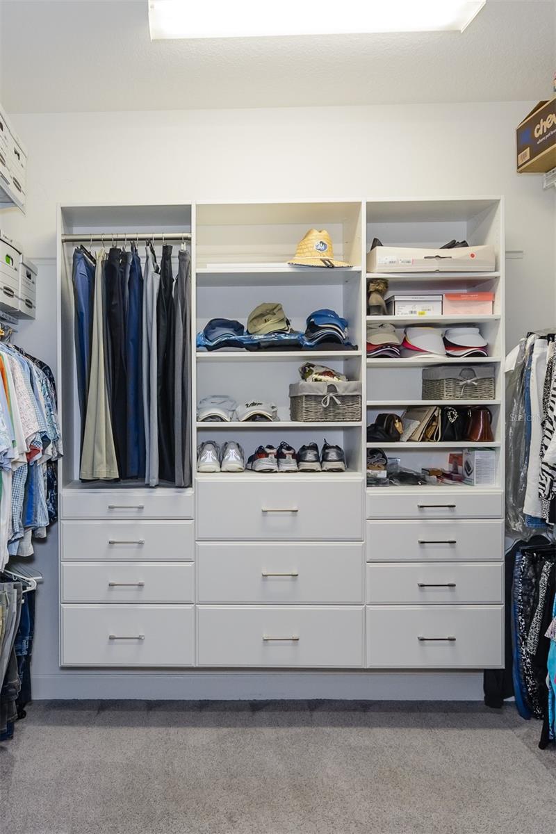 Master bedroom (10X10)walk in closet with custom cabinets.