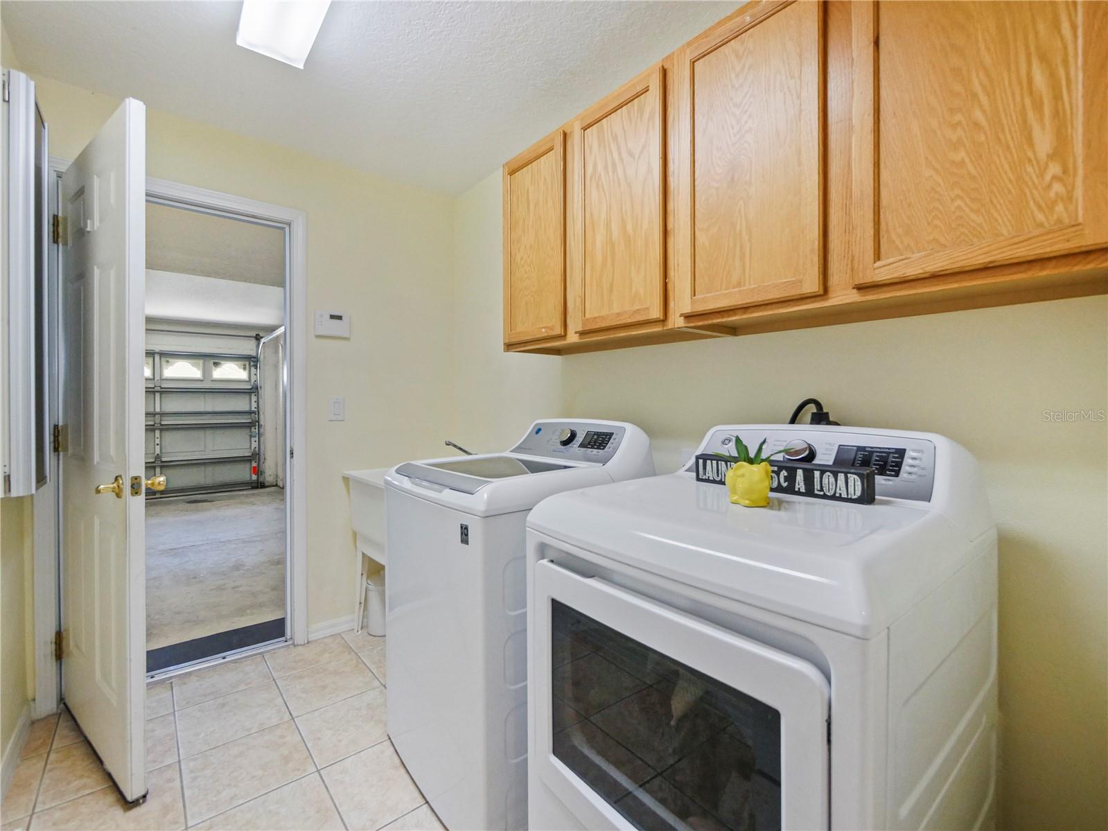 Laundry Room with entrance to 3 car garage