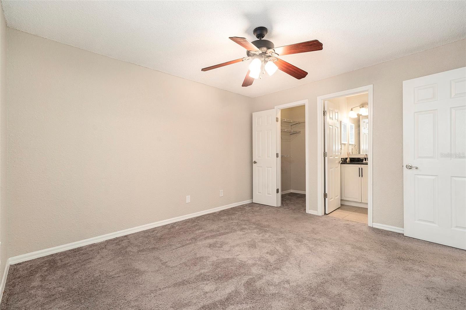 Large primary bedroom suite with walk in closet & full bathroom