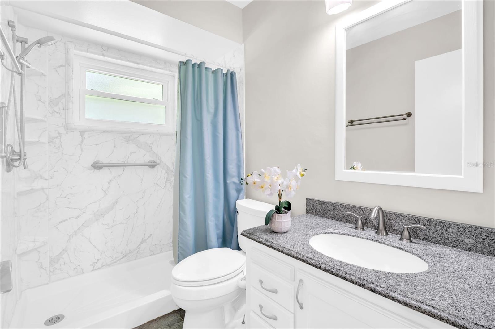 Updated full bath with updated walk-in shower, newer vanity & updated lighting~