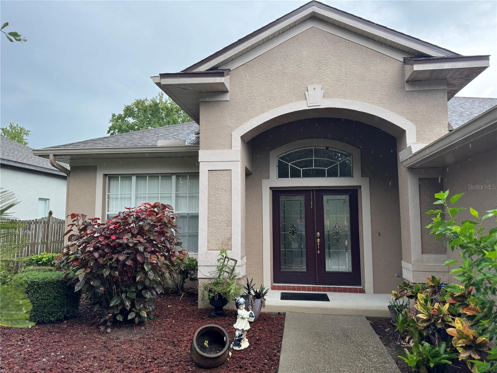 Welcoming entrance with mature landscaping