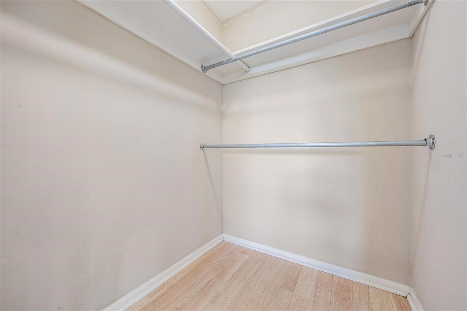 Primary bedroom walk-in closet