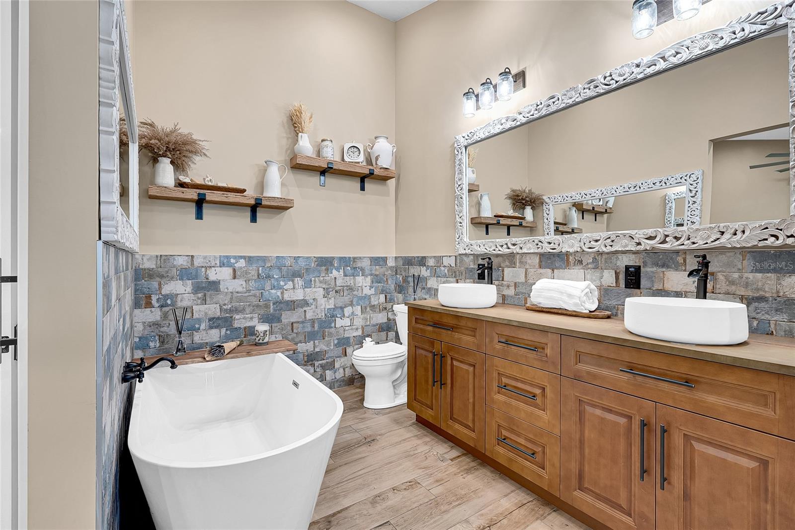 Primary ensuite with dual vanity, soaking tub and large shower