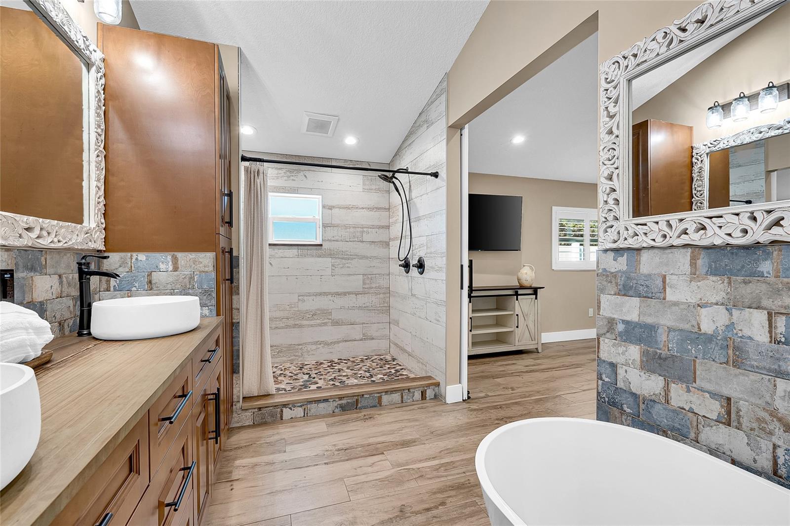 Primary ensuite dual head shower, soaking tub and dual vanity