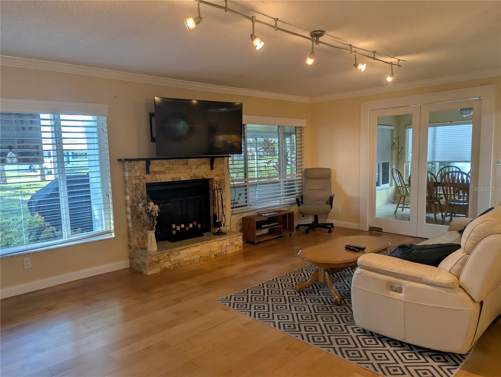 Florida room focal point is the stone fireplace and view.