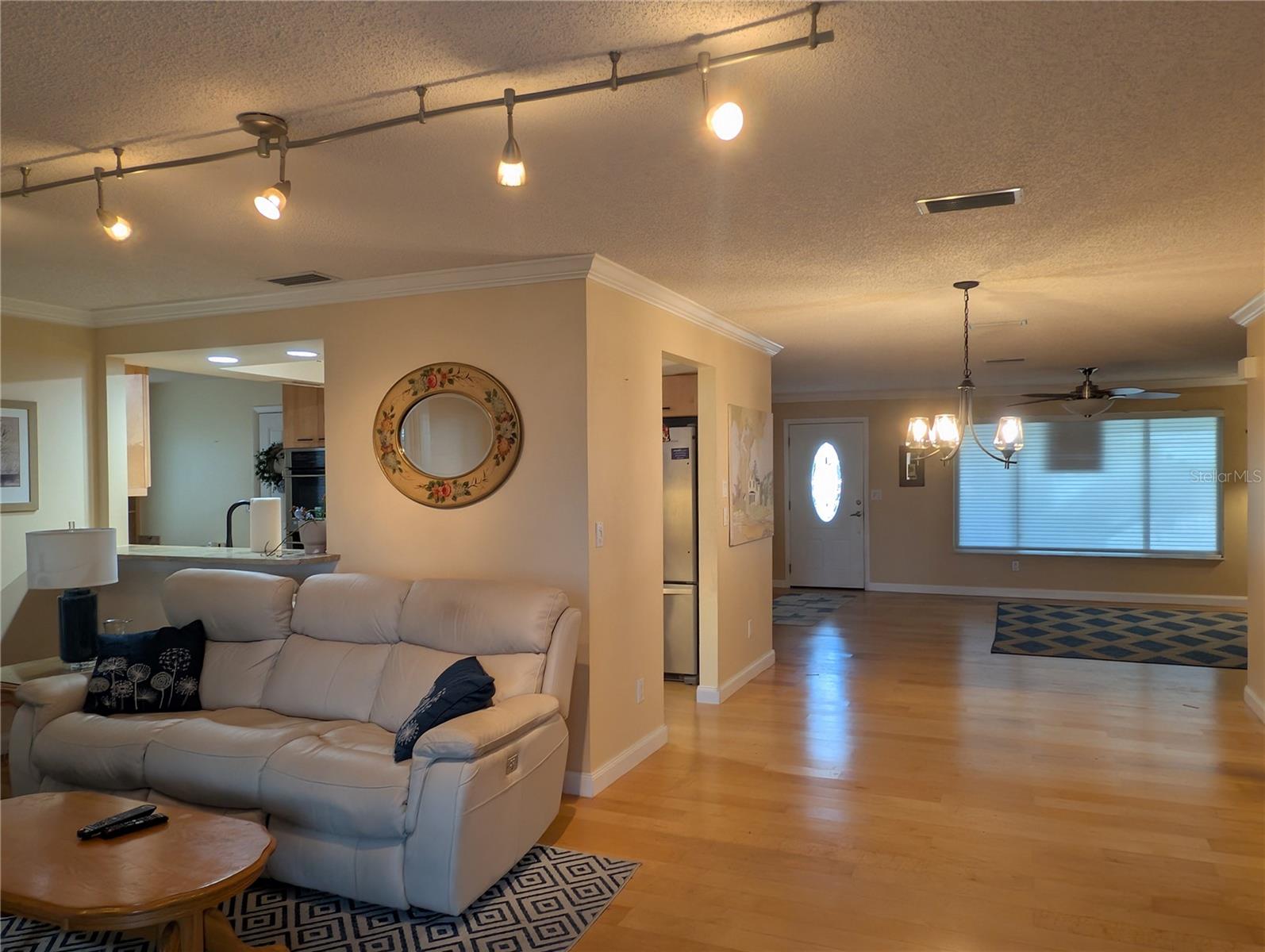 View from Florida room to front entry.  The Kitchen is truly the "Heart of this Home".  Centrally located between the Sun/Florida/Dining and Living rooms with direct access to the garage.